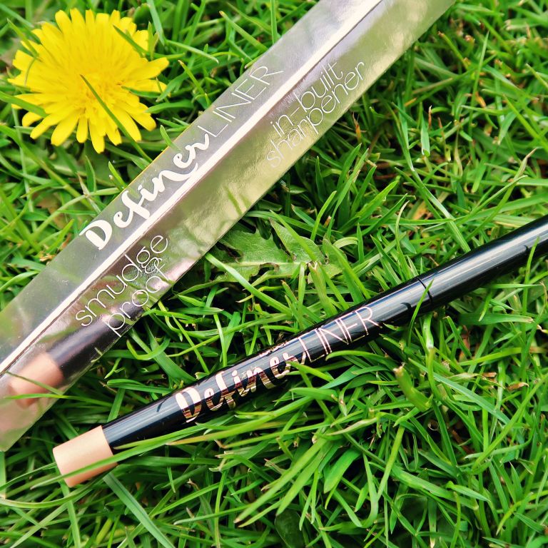 Ciate Definer Liner eye pencil laid on top of grass
