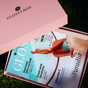 Pink Glossybox beauty box with lid open to reveal information card inside. The Dreaming in Paradise edition Glossybox.