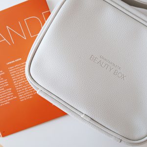 Close up of a white leather look travel bag embossed with the wording Lookfantastic Beauty Box