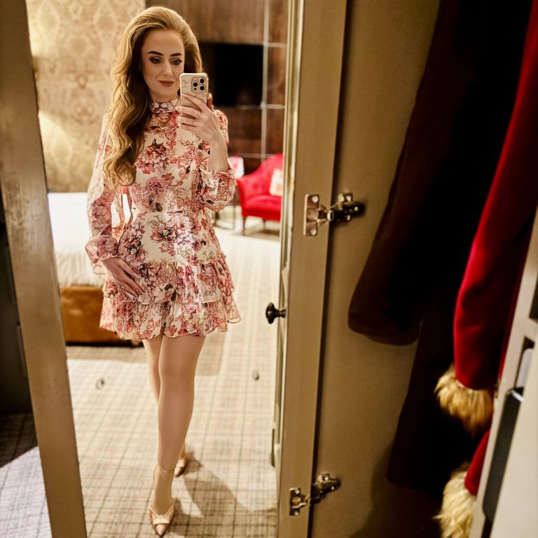 Girl wearing high neck floral dress taking a mirror selfie