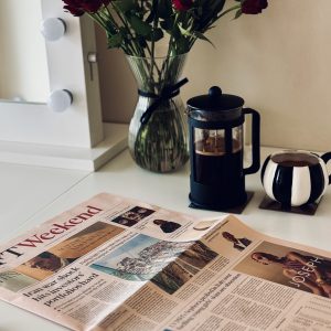 Cosmeticorexia: A flat-lay photograph of the Financial Times Weekend newspaper featuring a headline about the Sephora skincare probe, alongside a cafetière of coffee, a striped mug, and red roses on a white desk